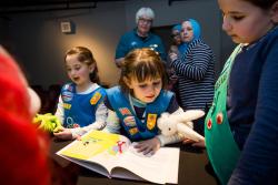 Two girl scouts reading a book