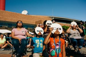 Family watching the solar eclipse safely