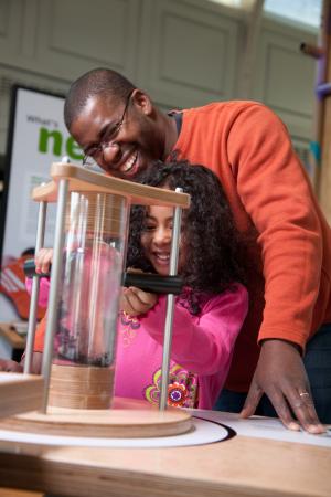 Father and daughter enjoying Small Smaller Nano ferrofluid activity in Nano exhibition