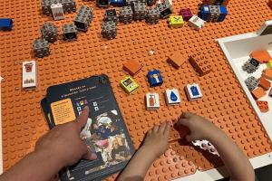 Build a Human Habitat on Mars - child building with bricks next to challenge cards