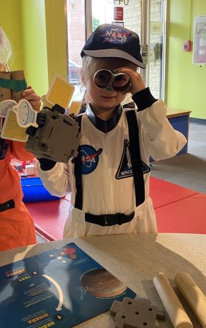 Hide & Seek Moon Activity with Child Dressed as Astronaut Holding Spacecraft & Handmade Binoculars