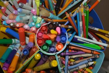Crayons colored pencils and markers on a table photo by Terry Jaskiw on Unsplash