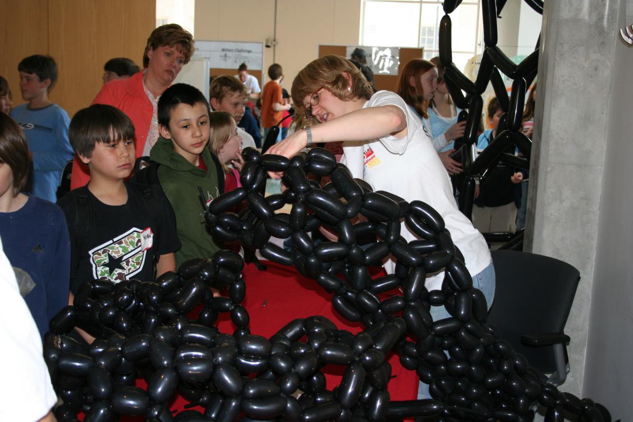 Group of students building a carbon nanotube model out of balloons 