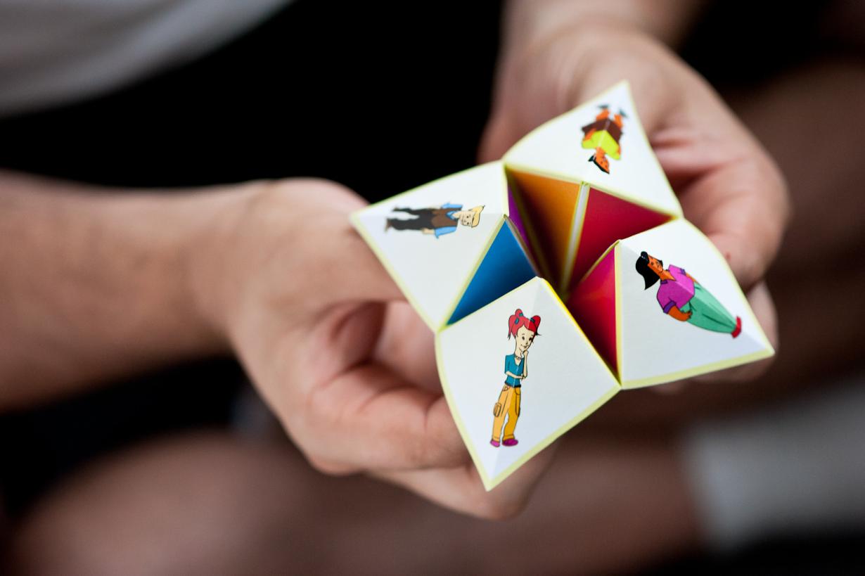 Learner holding the origami-folded game in their hands
