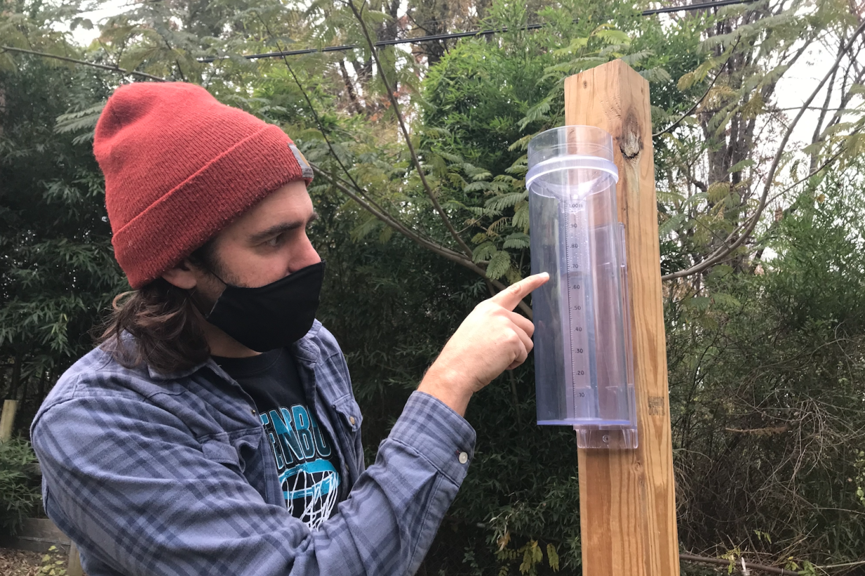 Citizen scientist taking a precipitation measurement on a CoCoRaHS rain gauge