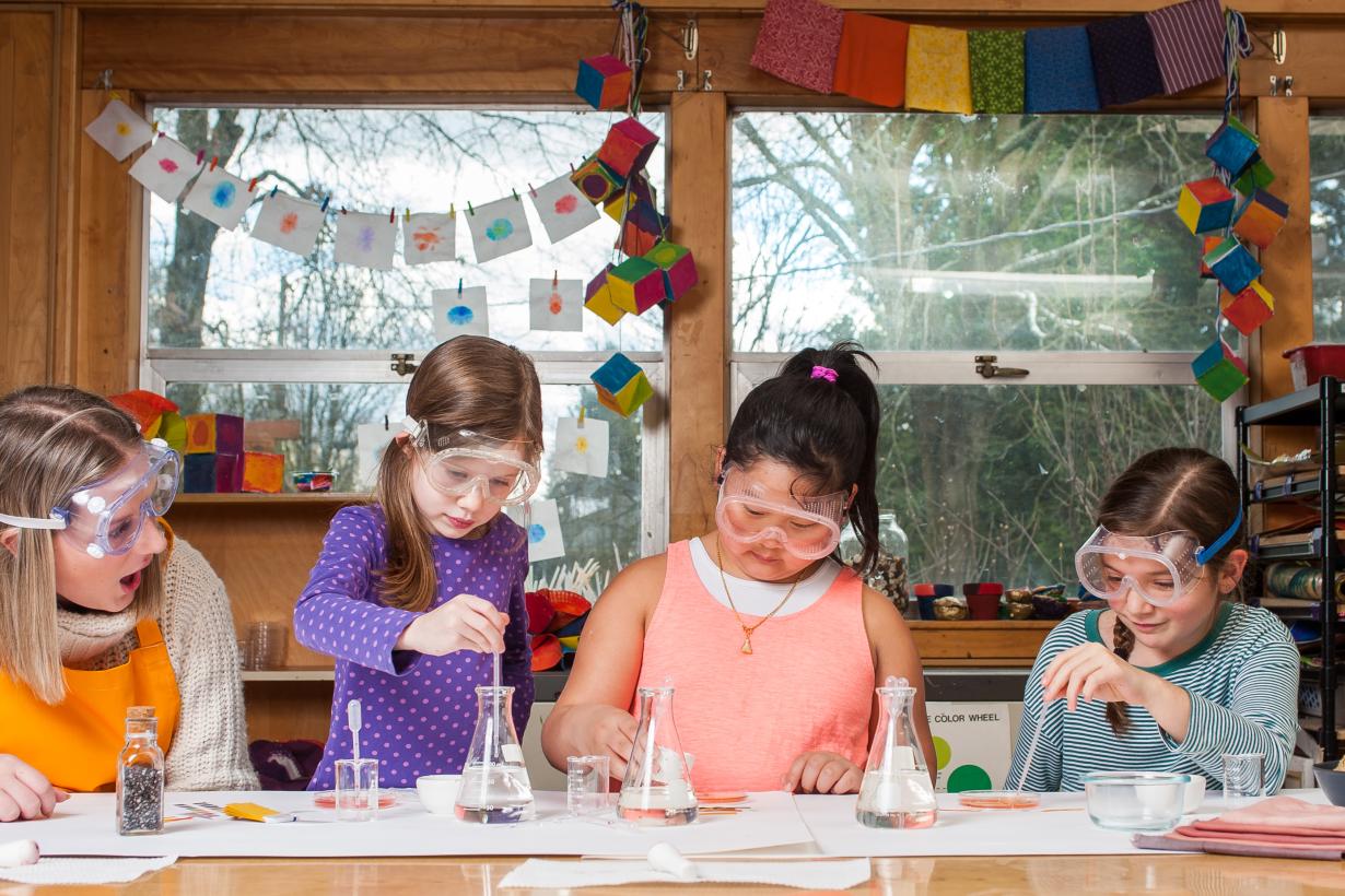 Childrens using Nature of Dye chemistry activity with tools and glassware
