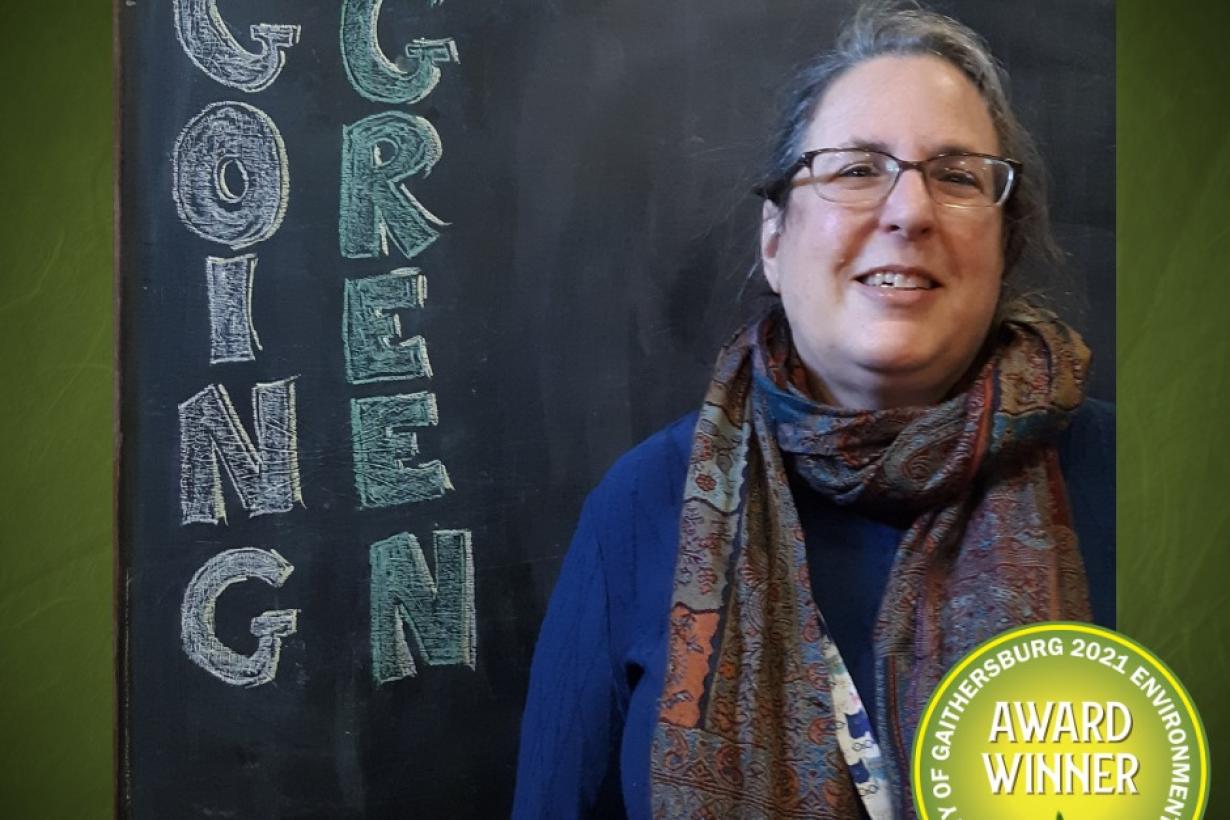 Photo of an Gaithersburg Museum educator accepting a going green award