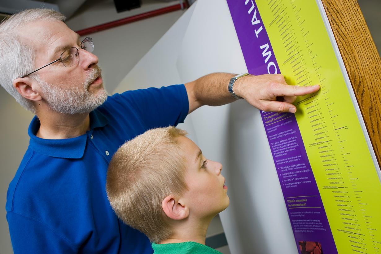 facilitator and young learner use a height chart set in nanometers