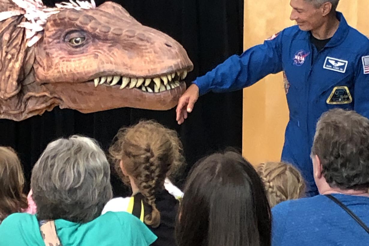 NASA Astronaut Mark Vande Hei at Science Museum of Minnesota 2019 Moon Landing anniversary event with giant dinoaur T-Rex puppet 