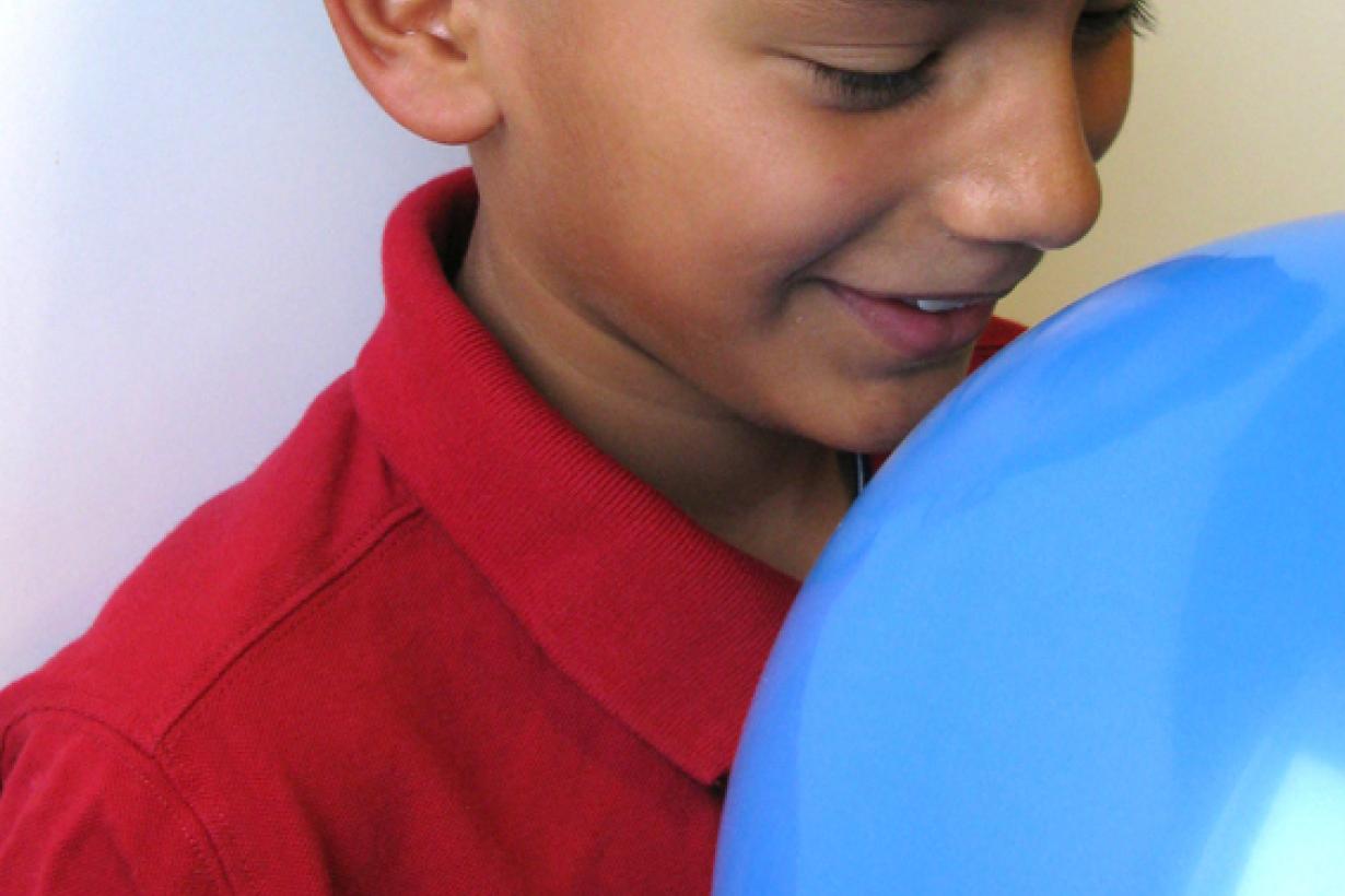 Child smelling balloon using Exploring Size - Scented Balloons NanoDays 