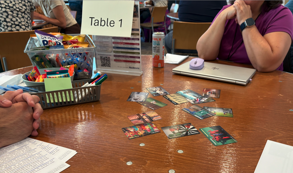 A handful of playing-size cards with colorful imagery are spread across a table.