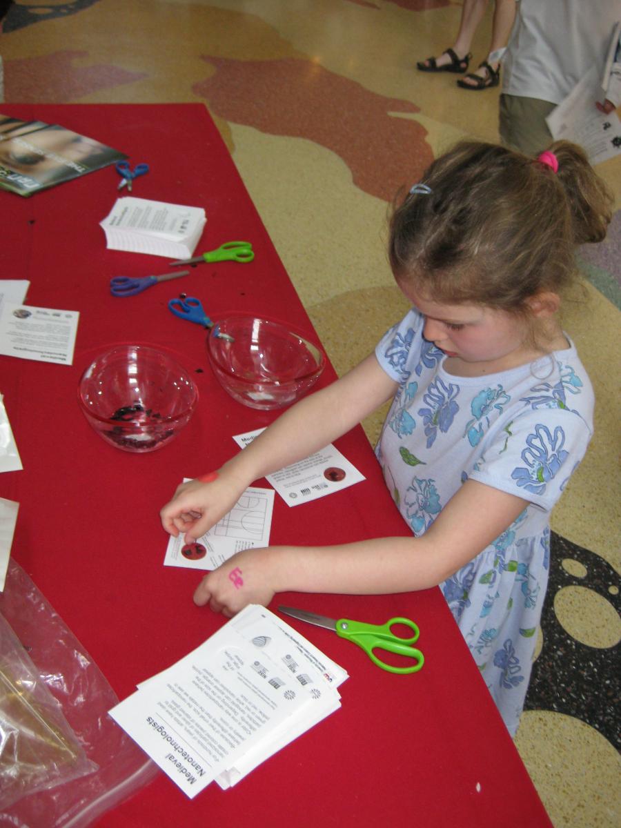 Learner making a take-away card with a small piece of stained glass