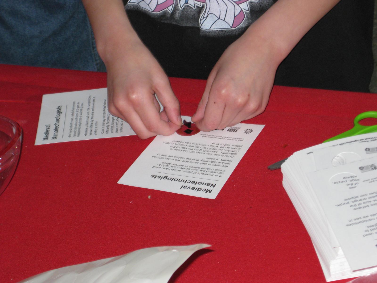 Learner making a take-away card with a small piece of stained glass
