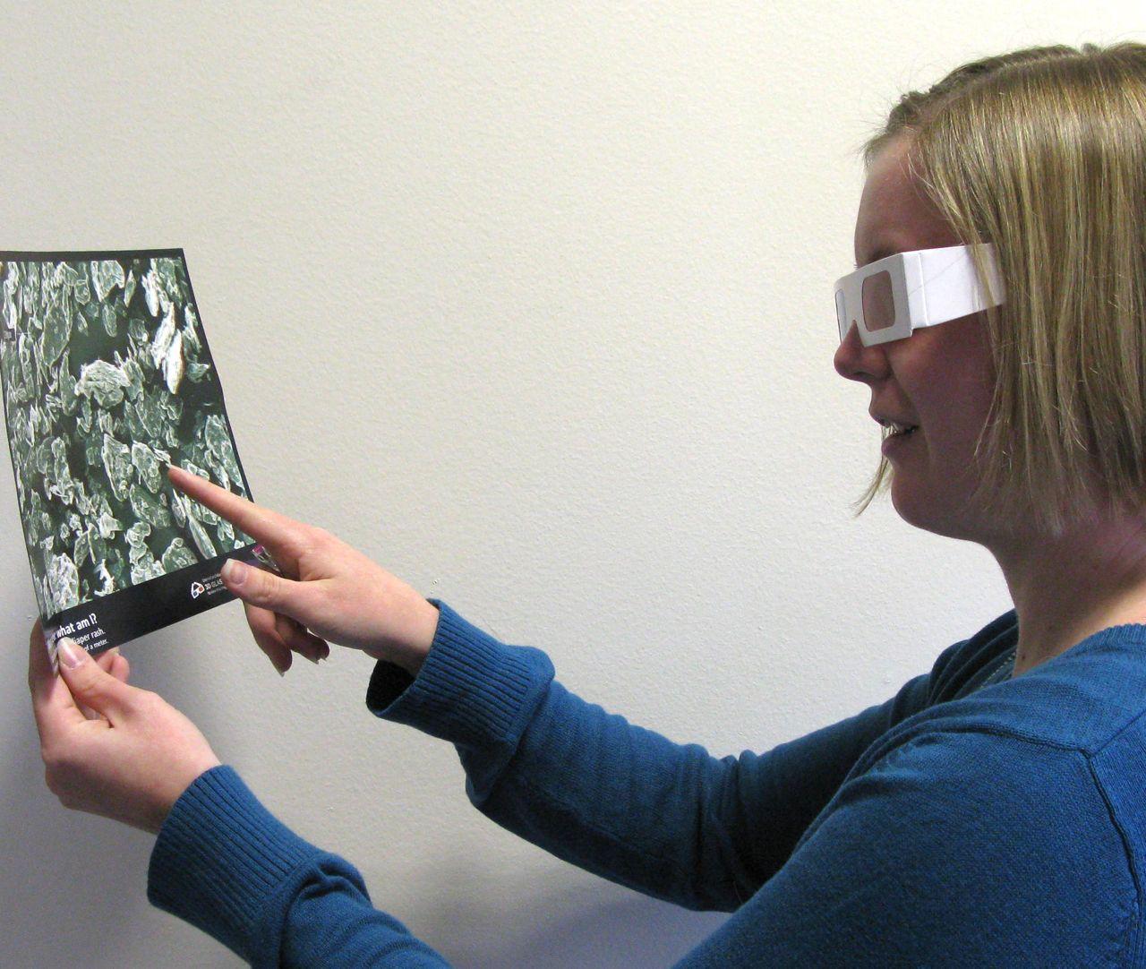 Learner uses 3D glasses to look at a image printed on a sheet of paper