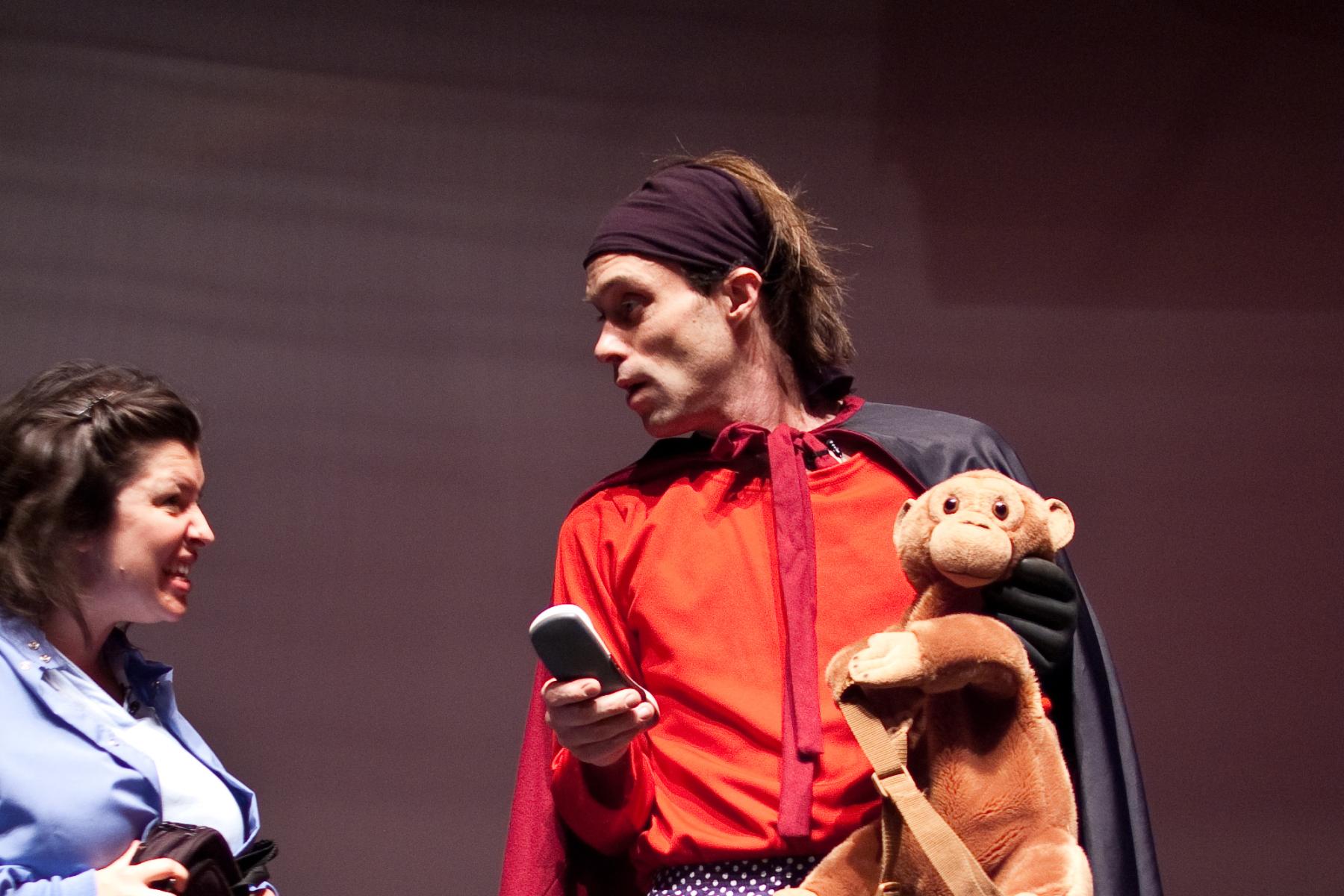 Actors in Attack of the Nanoscientists stage show dressed in superhero outfit with stuffed monkey toy