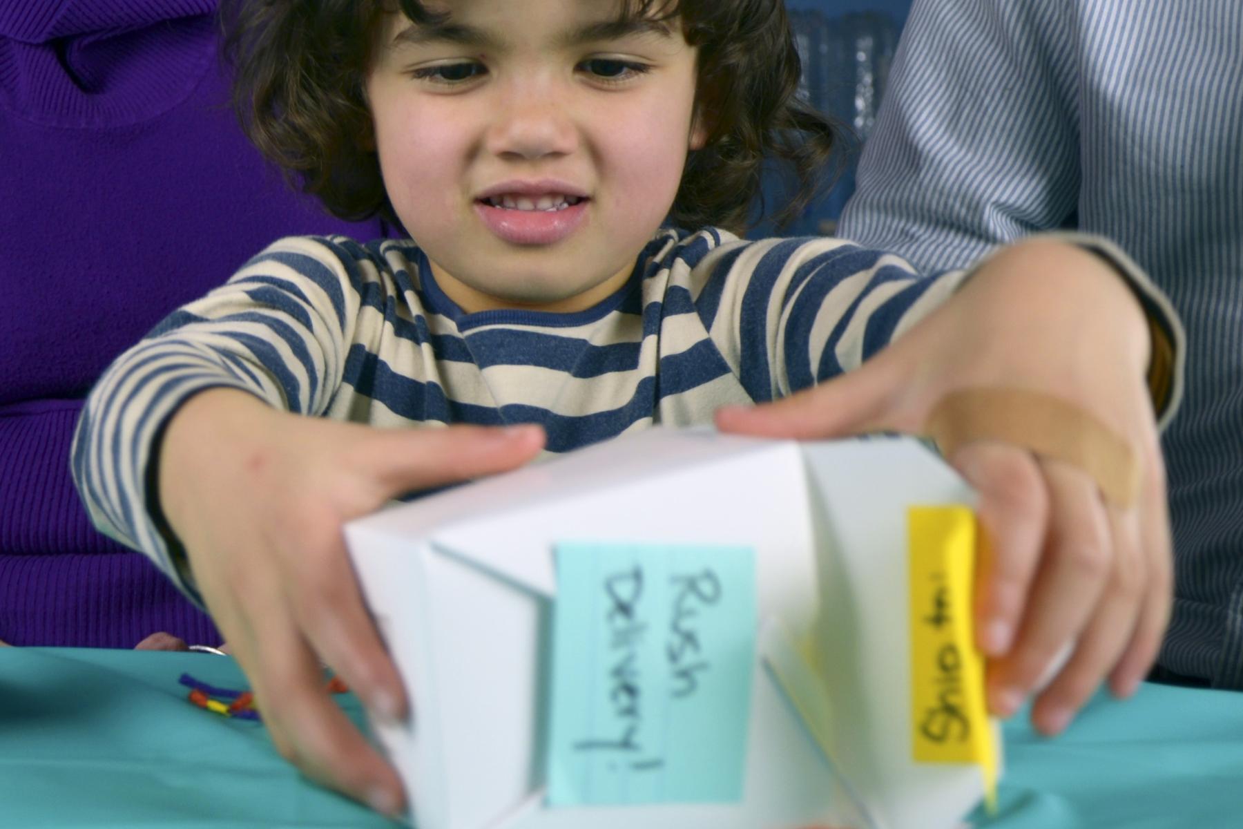 Young learner assembling a VirEx container with crafting supplies 