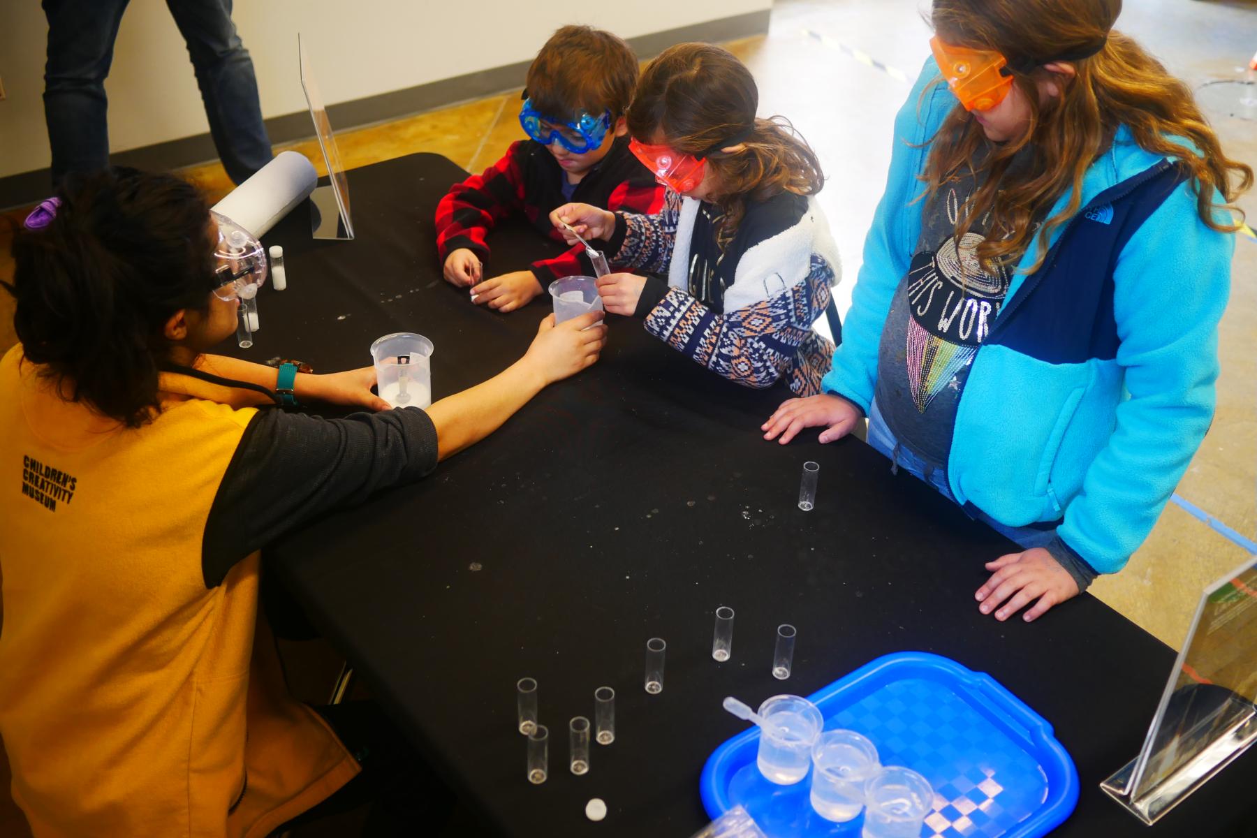 A group of learners load a small tube with citric acid, baking soda and water for a small chemical reaction