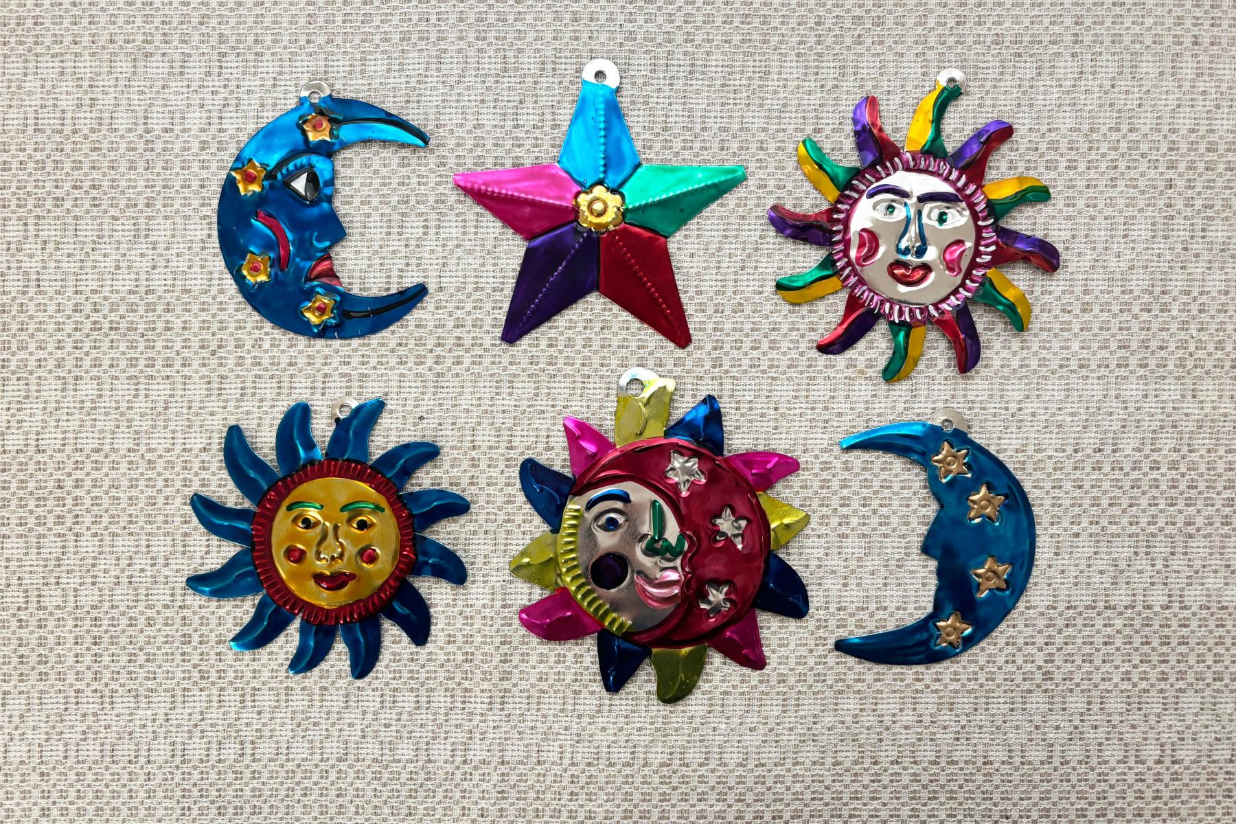 Ancestral Astronomy Finished examples of hojalata artwork including stars and moons.