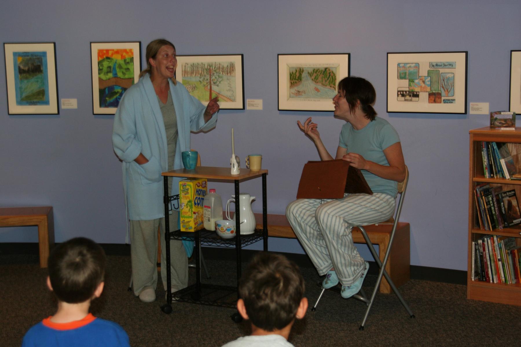 Two actors act in a play about nano and society.