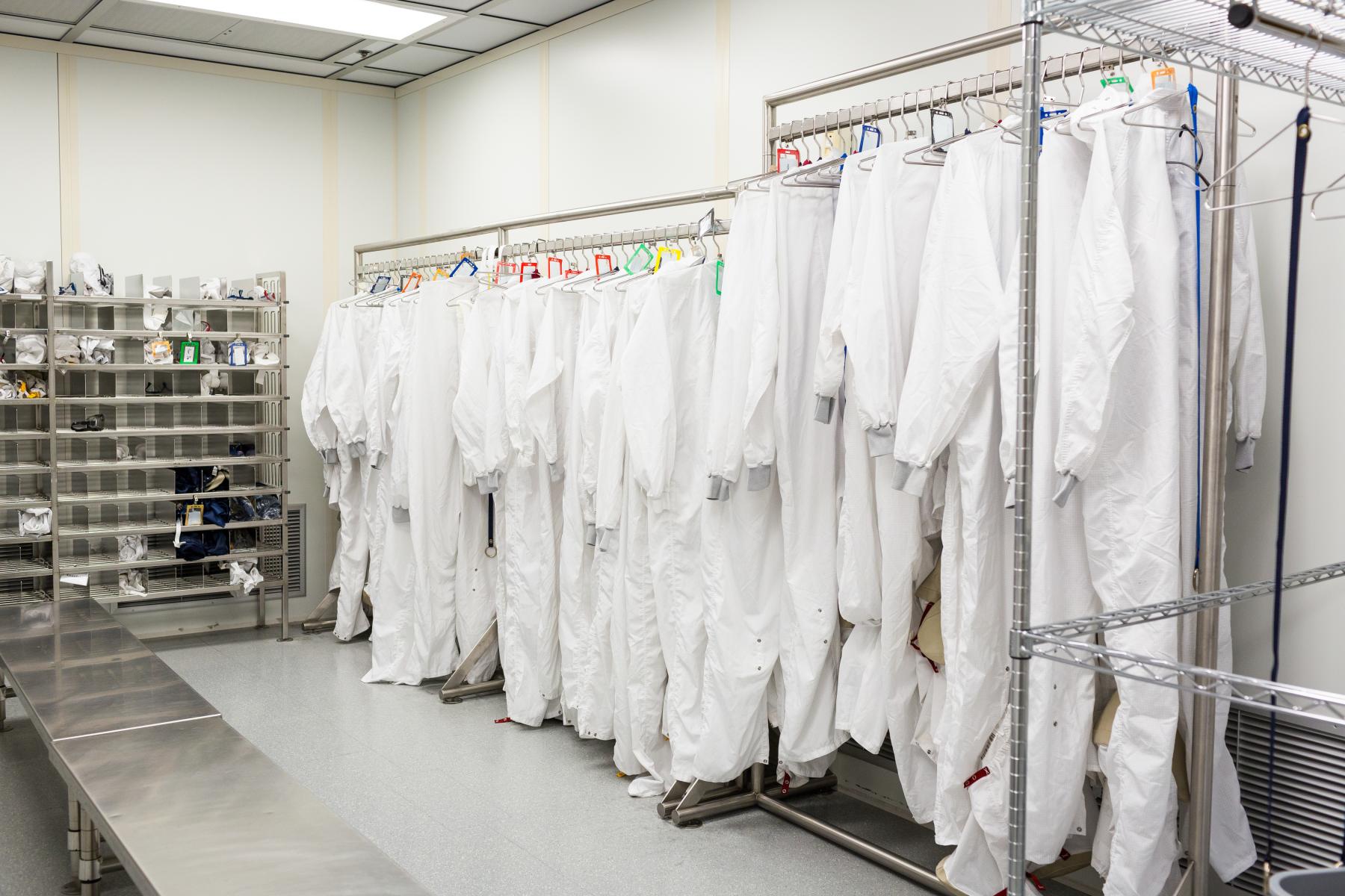 Photograph of cleanroom suits on a rack used in a nanotechnology fabrication lab.