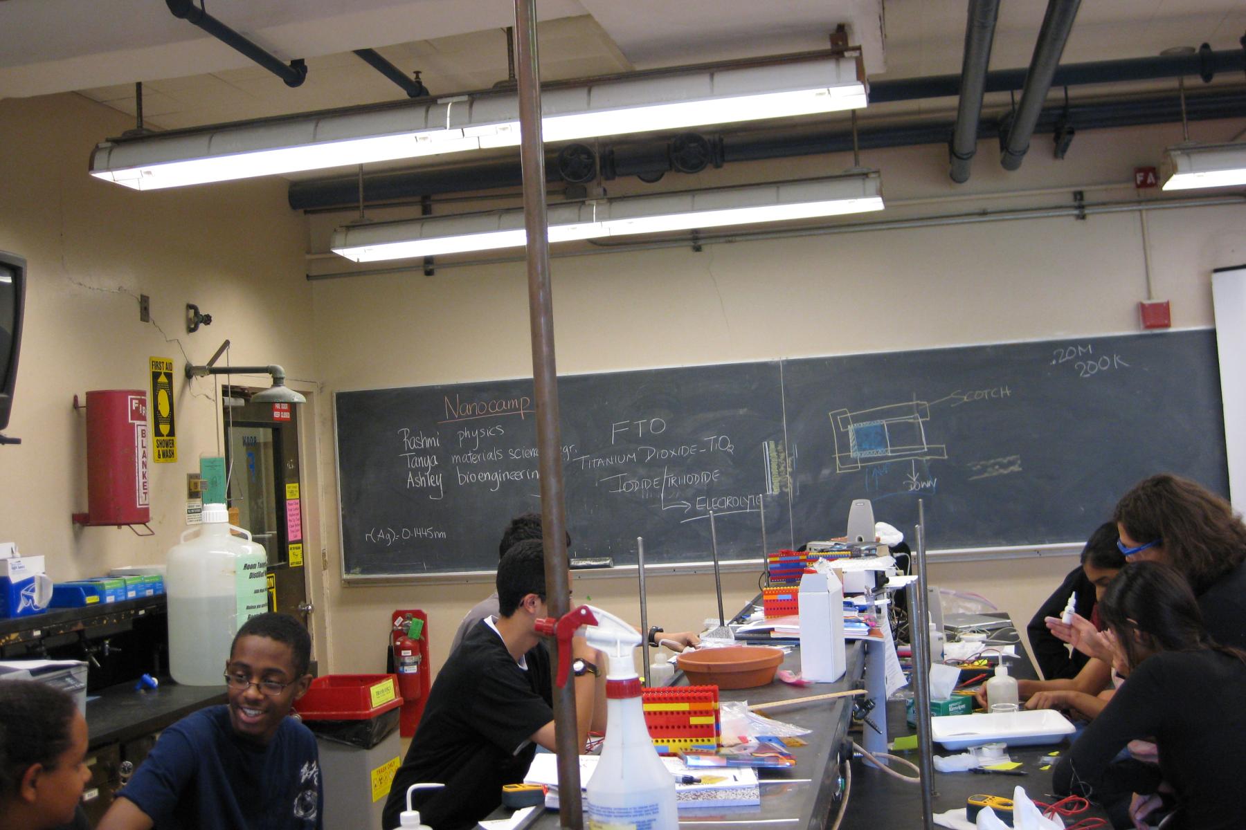 A candid shot of a class of high school students in a science lab.