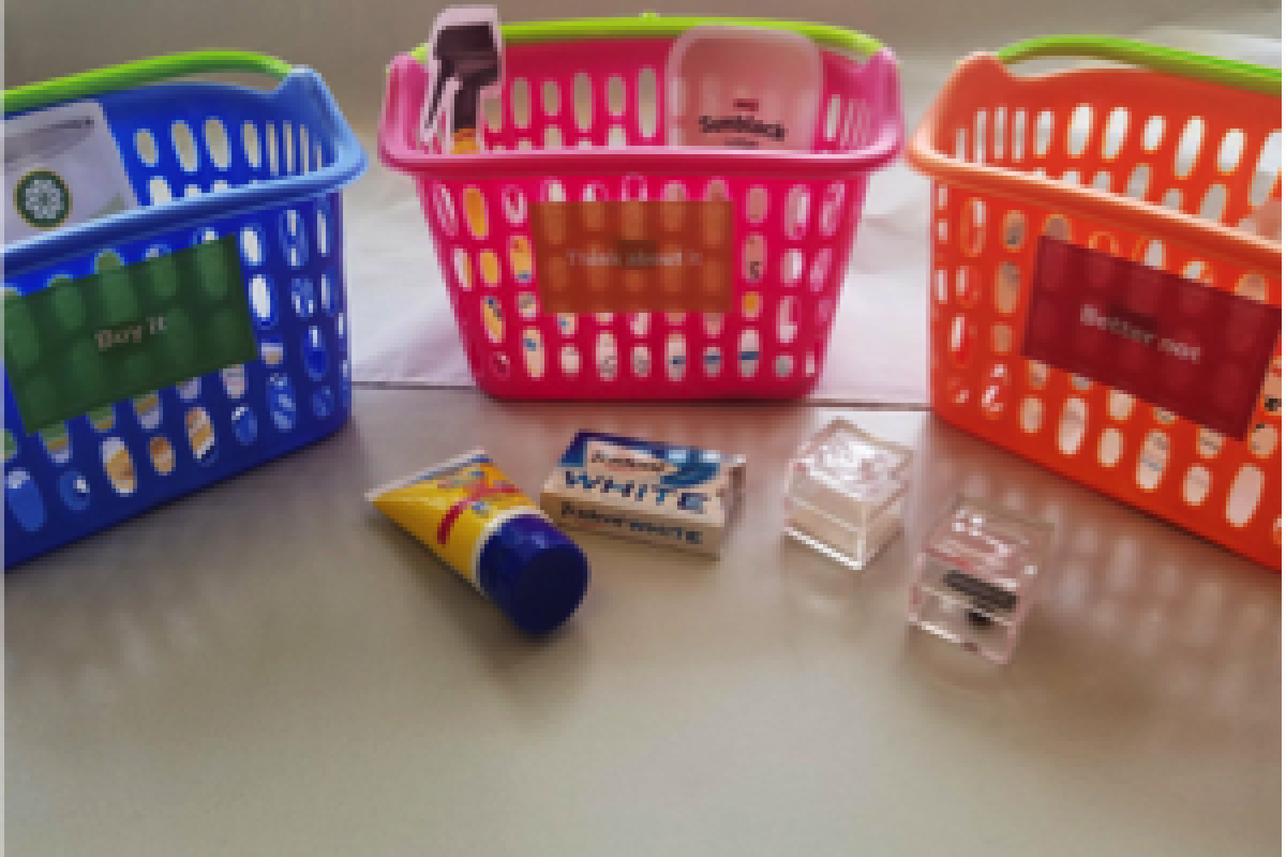 Plastic grocery baskets along with grocery store purchases including sunblock