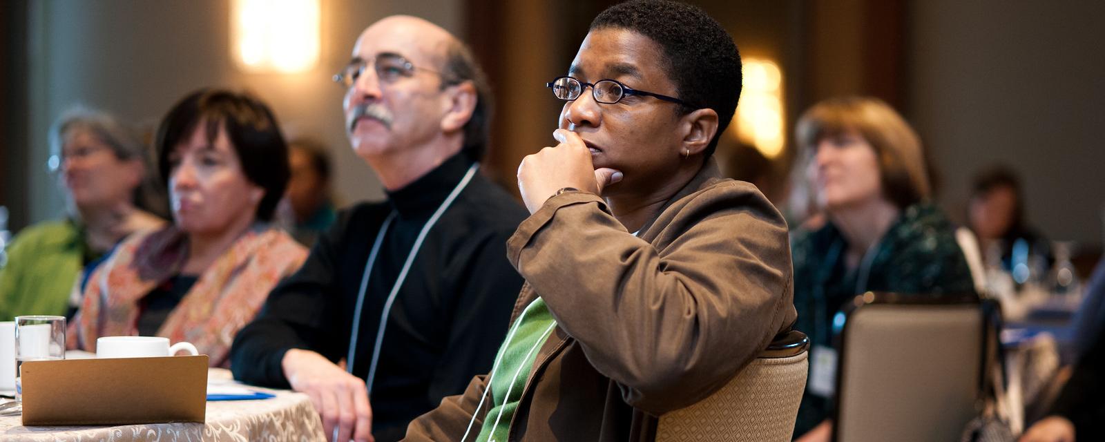 Conference Attendees listen to a speaker